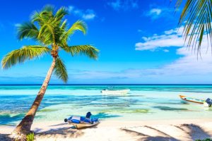 palm-trees-on-the-caribbean-tropical-beach-with-boats-saona-island-dominican-republic-vacation-travel-background-1280x720